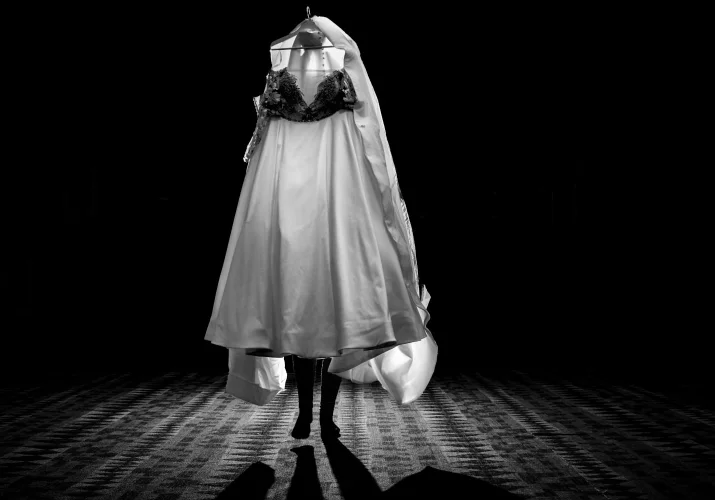 Bride carries a wedding dress in Banff. Photograph in black and white taken by talented Banff Wedding Photographer.