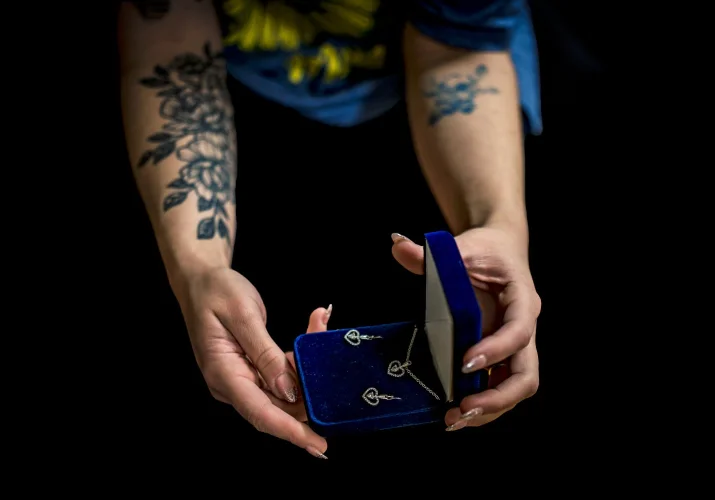Bridesmaids hands with jewellery box with wedding earnings and necklace.