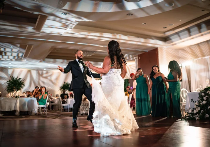 First dace at the Nigerian wedding in Calgary. Newlyweds dance at the dance floor while all the quest adore them.