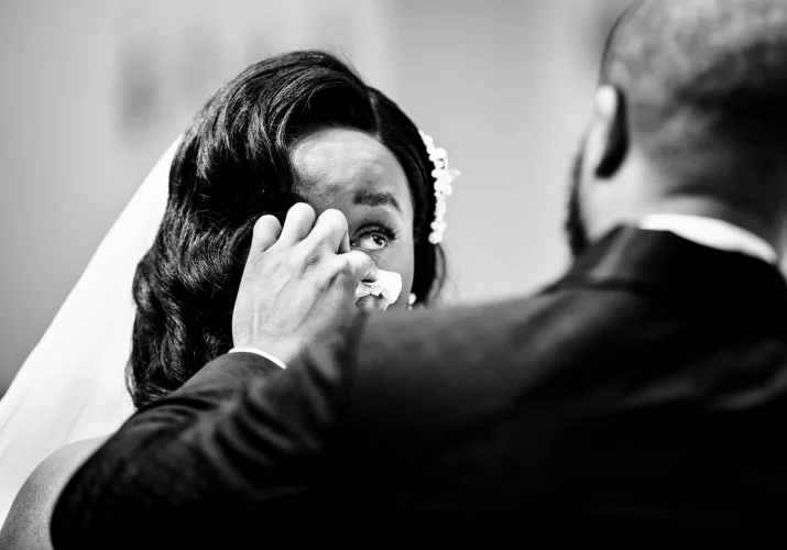 The groom wipes his wife to be cheek as she cries at the Calgary Wedding Ceremony.