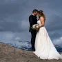 Bride and groom's portrait in the Canadian Mountains. They touches their foreheads.
