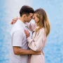 Couple in love touches their heads and hug during their engagement session inn Banff