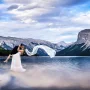 The best creative Banff Wedding Photographyat Minnewanka Lake. Newlyweds wild dance with flying veil.